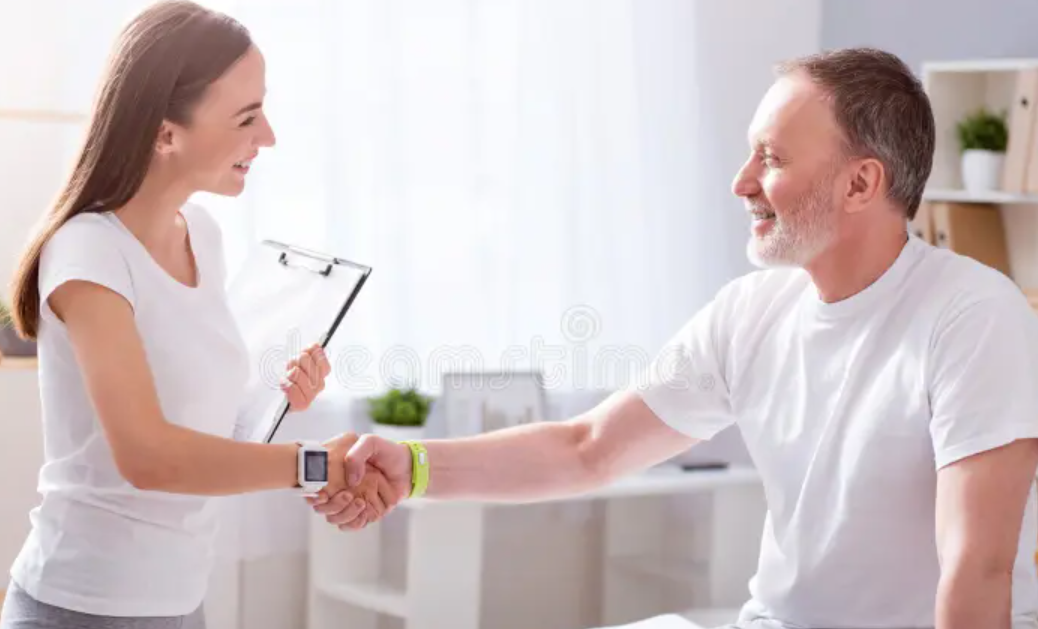 a physiotherapist shaking the patient's hand